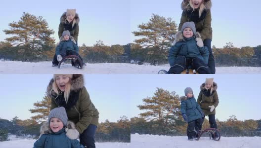 一家人在冬天的森林里休息，妈妈在新鲜的空气中推着快乐的儿子在雪橇上高清在线视频素材下载