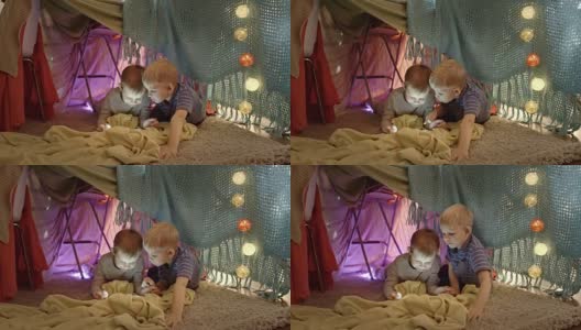 可爱的男孩在游戏帐篷中使用平板电脑高清在线视频素材下载