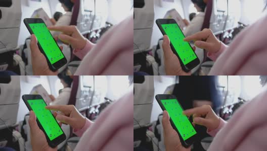 近距离女人手向上滚动绿色屏幕的手机应用在飞机座位上高清在线视频素材下载
