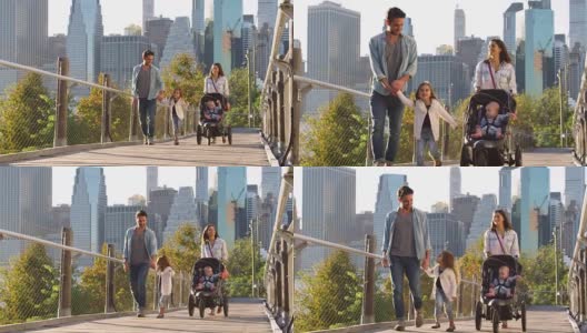 年轻的家庭在曼哈顿人行桥上推着婴儿车散步高清在线视频素材下载