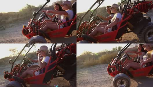 年轻的女孩们开着沙丘车在土路上享受极端的休息。极端的旅行高清在线视频素材下载