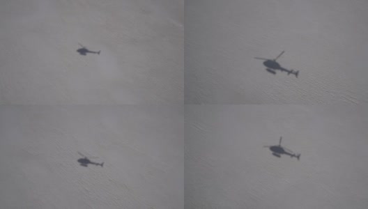 直升机阴影在雪地上空飞行高清在线视频素材下载
