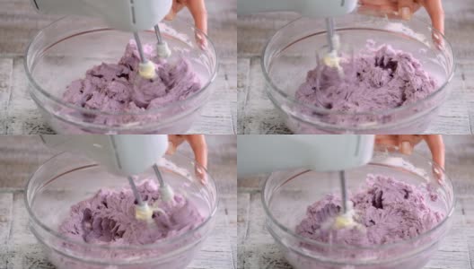 糕点师用搅拌机搅拌蓝莓奶油高清在线视频素材下载