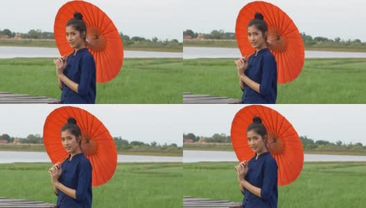 年轻的亚洲妇女穿着泰国风格的传统服装。高清在线视频素材下载