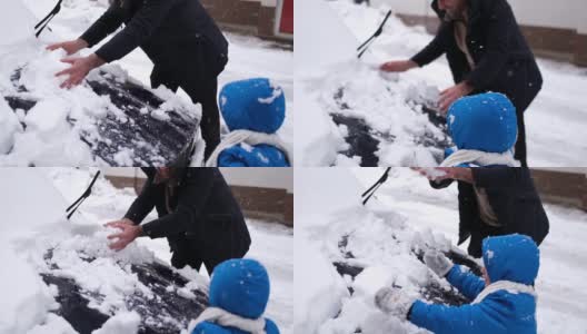 一家人在冬天清除汽车上的雪高清在线视频素材下载