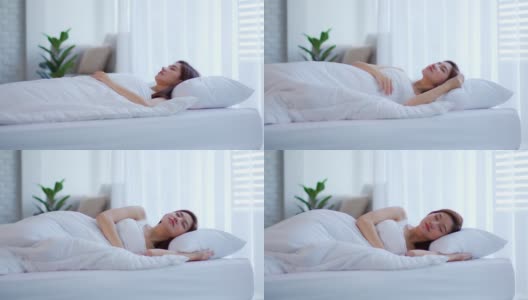 美丽迷人的亚洲女人在卧室的床上睡觉和甜蜜的梦在早上感觉如此放松和舒适，保健理念高清在线视频素材下载