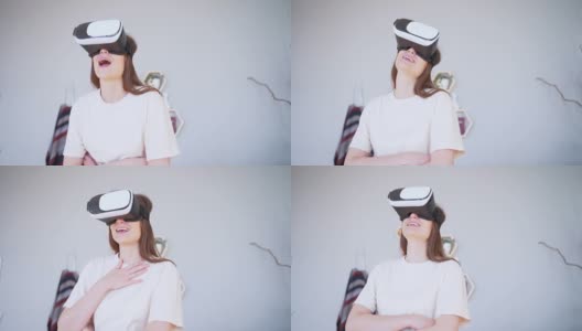 虚拟的幸福。一名年轻女子戴着虚拟现实耳机大笑高清在线视频素材下载
