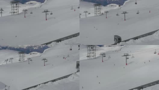 在许多滑雪者下降速度的雪道上种植升降椅、缆绳和升降机高清在线视频素材下载