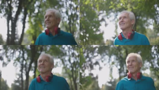 特写快乐的老年人健康的人慢跑在阳光户外微笑看着别处。自信的白人退休人员在夏季春天公园慢动作锻炼跑步的肖像。运动和健康。高清在线视频素材下载