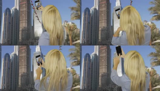 在商业摩天大楼对面用智能手机自拍的快乐女人高清在线视频素材下载