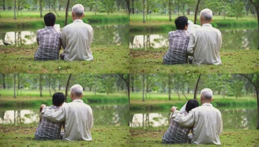 亚洲资深夫妇从后面拍摄坐在公园里一起看书高清在线视频素材下载