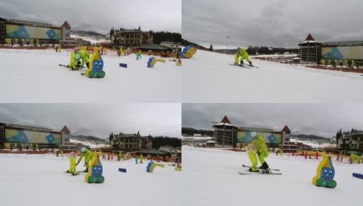 一个教练教一个小女孩如何滑雪。高清在线视频素材下载