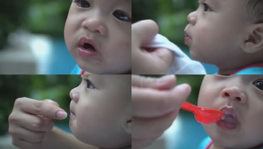 可爱的婴儿在吃婴儿食品高清在线视频素材下载