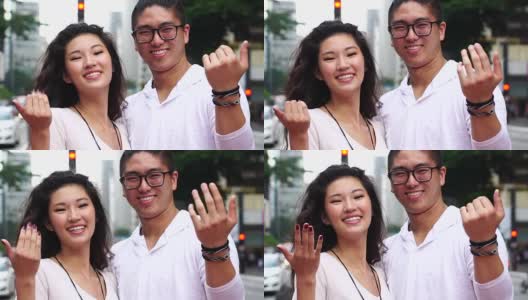 年轻的亚洲夫妇邀请别人来高清在线视频素材下载