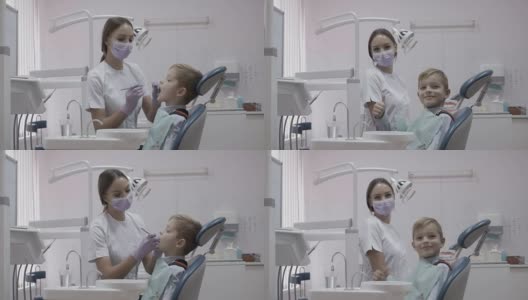 小男孩翘着大拇指坐在牙医的椅子上高清在线视频素材下载