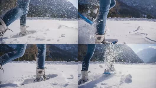 在白雪覆盖的山坡上穿雪鞋的女人高清在线视频素材下载
