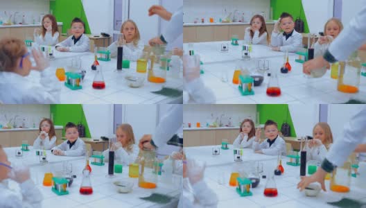 化学课上的孩子们。小学化学课-化学实验。教育、儿童、科学和概念高清在线视频素材下载