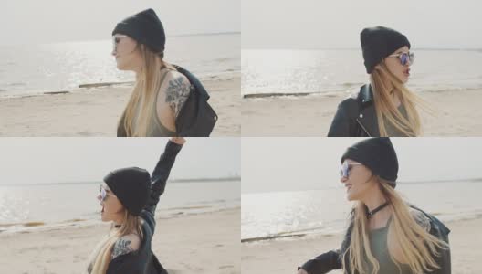 美丽的年轻的纹身女孩金发是在海滩上跳舞的特写慢动作高清在线视频素材下载
