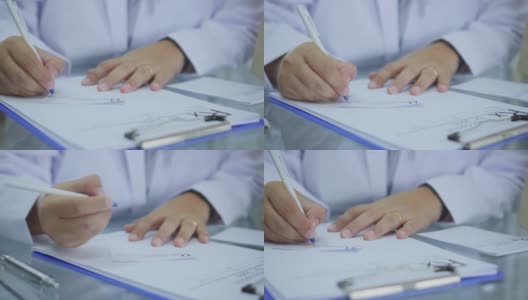 药剂师在桌子上写处方的特写，慢镜头高清在线视频素材下载