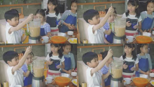 一群亚洲孩子在学校的厨房里准备水果奶昔，学习和教育的概念高清在线视频素材下载