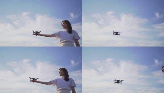 女子将无人机从手掌中发射出来。在天空中起飞四轴飞行器，变换焦点高清在线视频素材下载