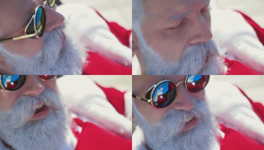 戴着太阳镜的圣诞老人在假期放松高清在线视频素材下载