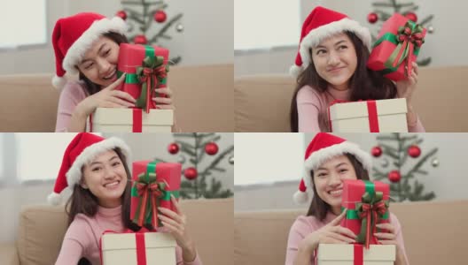 快乐美丽的亚洲女人庆祝堆放许多礼物礼盒在圣诞晚会。可爱的女孩在圣诞节假期拿着用丝带和蝴蝶结装饰的礼盒。春节快乐。高清在线视频素材下载