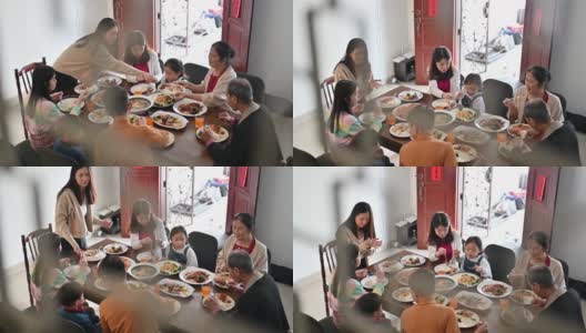 欢乐的亚洲三代家庭在春节期间在家里庆祝和享受团圆饭高清在线视频素材下载