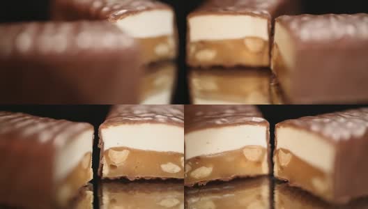 美味的焦糖和坚果棒顶部的巧克力釉，糖果店高清在线视频素材下载