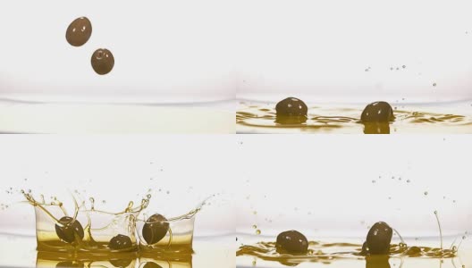 在白色背景下，橄榄落入橄榄油，慢镜头4K高清在线视频素材下载