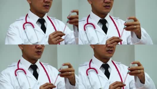 医生用注射器从药瓶中吸药治疗病人高清在线视频素材下载
