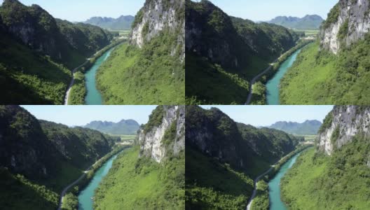 空中陡峭的岩石河岸和公路在绿色峡谷高清在线视频素材下载
