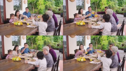 微笑亚洲多代家庭祝酒果汁高清在线视频素材下载