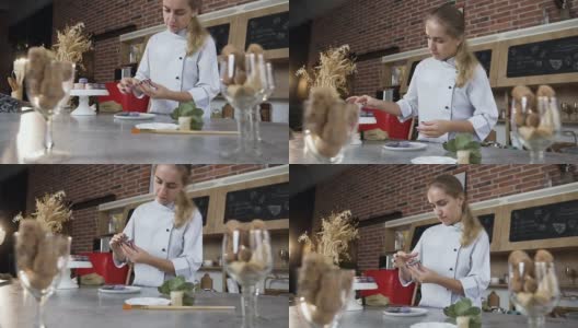 年轻的女厨师用奶油将两半的杏仁蛋白杏仁饼连接起来高清在线视频素材下载