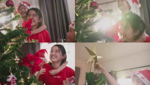 一个亚洲少女和她的哥哥姐姐在圣诞节的时候在家里的客厅里装饰圣诞树。高清在线视频素材下载