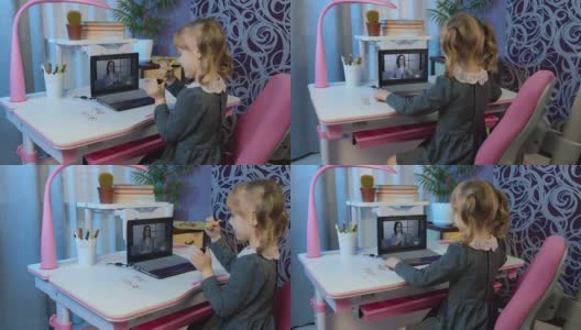 学龄前儿童女孩在家远程在线教育，小学生在笔记本电脑上观看视频课程高清在线视频素材下载