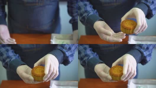 亚洲男子举着一个刚烤好的中国月饼高清在线视频素材下载