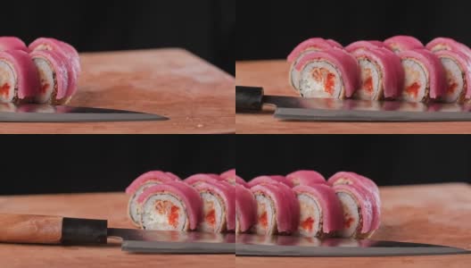 天妇罗卷刀切板。寿司有金枪鱼，米饭，虾，鱼子酱高清在线视频素材下载