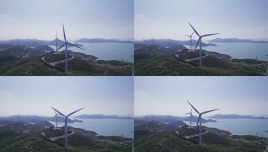 在海边的山顶上安装了风力涡轮机高清在线视频素材下载