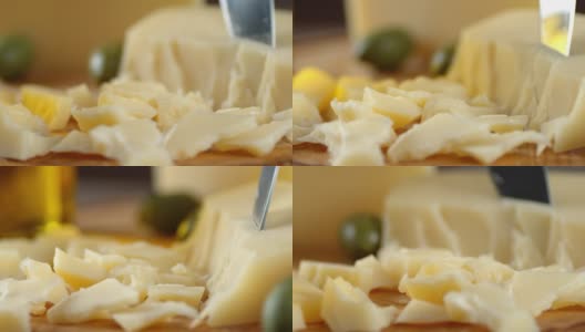 一片片的帕尔玛干酪在一张木桌上慢慢地旋转着。高清在线视频素材下载
