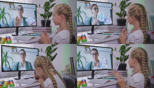 远程教学时，女孩在家里用电脑向女老师展示带数字的卡片高清在线视频素材下载