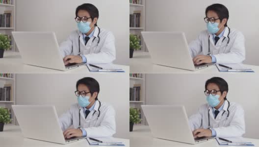 亚洲医生在办公室使用笔记本电脑时戴上眼镜和口罩高清在线视频素材下载