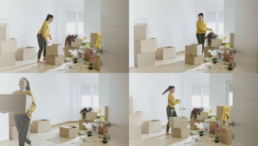 一个女人在她的新公寓里拿着纸板箱高清在线视频素材下载