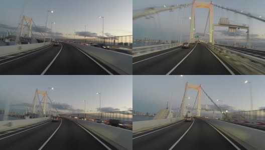 夕阳下的司机穿过东京彩虹桥。高清在线视频素材下载