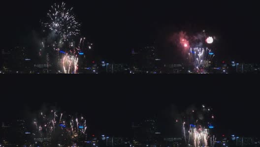 夜晚，烟花在城市上空飞舞。节日及庆典背景高清在线视频素材下载