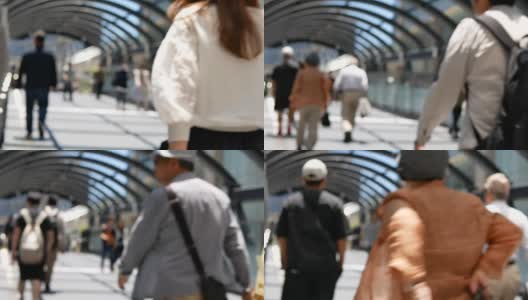 在日本大阪车站的高峰时段，一群无名的人走在人行道上。高清在线视频素材下载