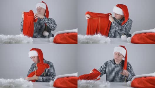 年轻人戴着圣诞老人的帽子看着圣诞老人的裤子50帧/秒高清在线视频素材下载