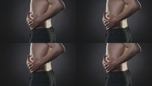 男人腹部疼痛，腹部疼痛在黑色背景上高清在线视频素材下载