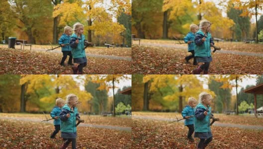 孩子们在秋叶上走，拿着树枝高清在线视频素材下载