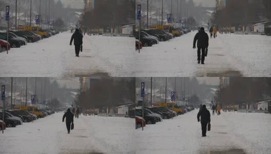 兰登，一个无法辨认的行人沿着积雪覆盖的小路走着。城市场景。贝尔格莱德,塞尔维亚高清在线视频素材下载